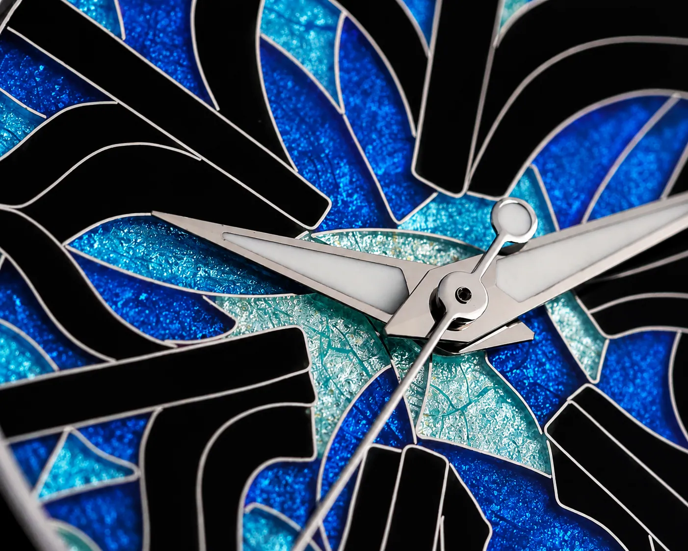 Macro detail of silver partitions and vivid blue enamel